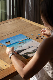 Boulders Beach is a MasterPiece wooden jigsaw puzzle from the African Odyssey poster series designed to showcases Africa’s most iconic natural wonders. Boulders Beach is a haven for African penguins.Precision-cut from 3mm thick wood and expertly printed, our MasterPiece puzzles offer a tactile and satisfying puzzling experience like no other. They are perfect for art lovers, nature enthusiasts and anyone looking for a thoughtful gift.