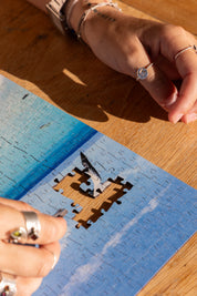 Boulders Beach is a MasterPiece wooden jigsaw puzzle from the African Odyssey poster series designed to showcases Africa’s most iconic natural wonders. Boulders Beach is a haven for African penguins.Precision-cut from 3mm thick wood and expertly printed, our MasterPiece puzzles offer a tactile and satisfying puzzling experience like no other. They are perfect for art lovers, nature enthusiasts and anyone looking for a thoughtful gift.