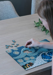 Person working on Starry Night 3mm luxury wooden MasterPiece Puzzle.