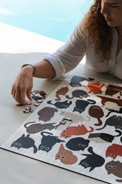 Curious Cats is a MasterPiece wooden jigsaw puzzle featuring a delightful collection of curious cats in various poses and playful scenes. This charming puzzle is a must-have for cat lovers! Precision-cut from 3mm thick wood and expertly printed, our MasterPiece puzzles offer a tactile and satisfying puzzling experience like no other. like no other. This puzzle is perfect for 'crazy cat ladies', art lovers and anyone looking for a thoughtful gift.
