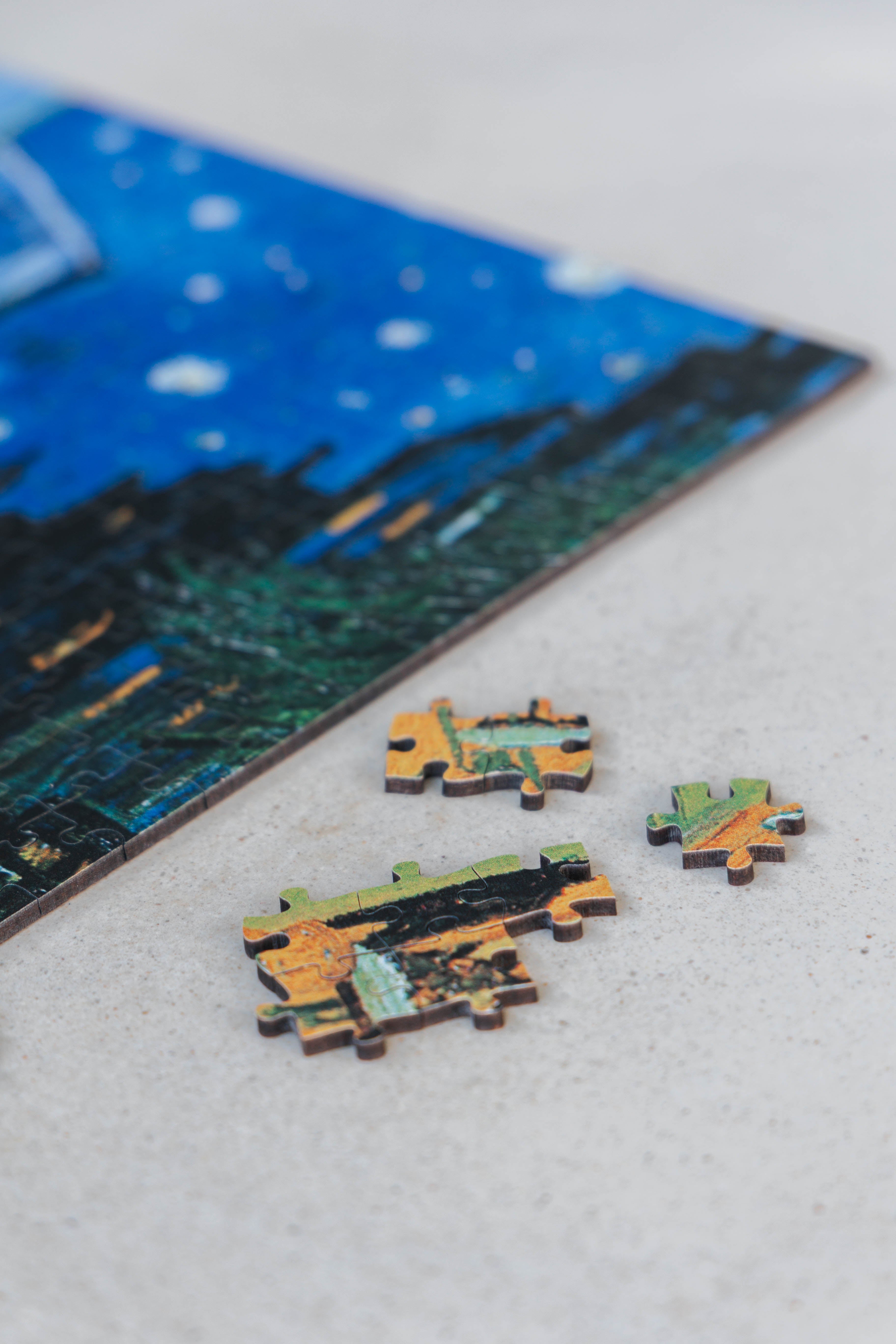 Café Terrace at Night is a MasterPiece wooden jigsaw puzzle of Vincent Van Gogh's painting featuring a warm glow of a café under a starry sky. Precision-cut from 3mm thick wood and expertly printed, our MasterPiece puzzles offer a tactile and satisfying puzzling experience like no other. They are perfect for classic art lovers and anyone looking for a thoughtful gift. 