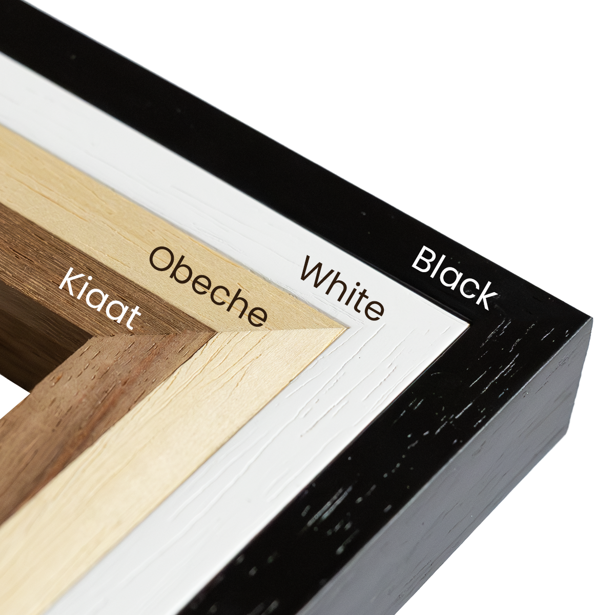 Four solid wood puzzle frame options displayed side by side in Black, White, Obeche, and Kiaat finishes, designed for A3 and A2 Masterpiece Puzzles with real glass fronts.
