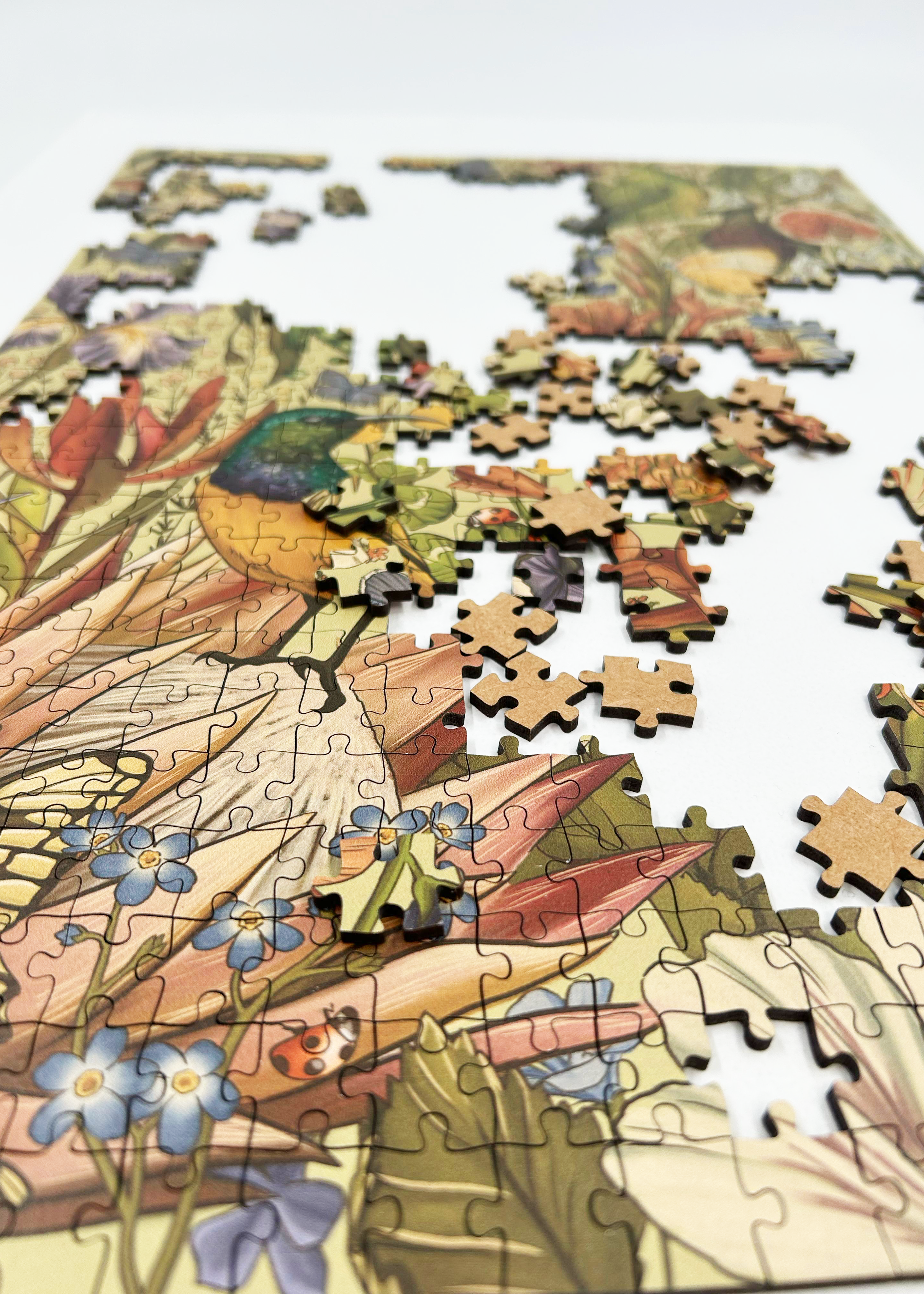 Fynbos Symphony is a MasterPiece wooden jigsaw puzzle that features a stunning nature-inspired illustration that is rich with diverse flora and fauna. Soft, earthy tones create a vintage botanical aesthetic, while vibrant birds and delicate insects bring the scene to life. Precision-cut from 3mm thick wood and expertly printed, our MasterPiece puzzles offer a tactile and satisfying puzzling experience like no other. They are perfect for art lovers, bird lovers and anyone looking for a thoughtful gift.