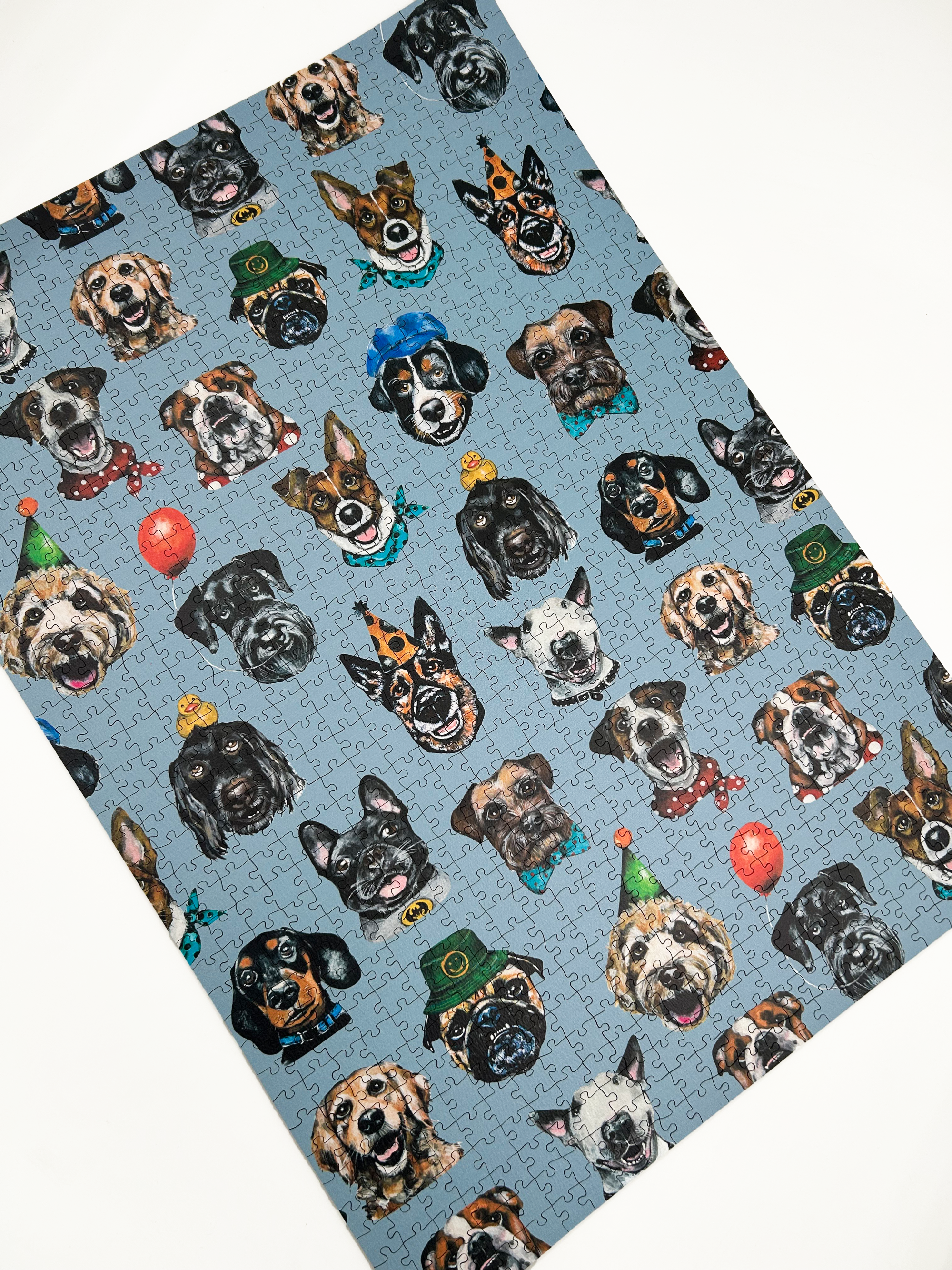 Wooden jigsaw puzzle with dog-themed pieces on a blue background