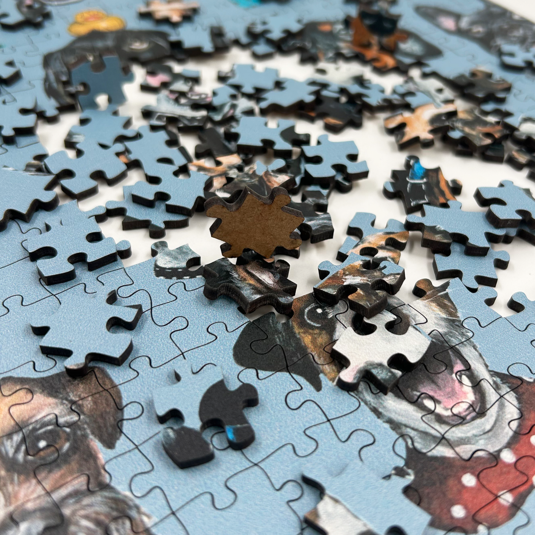 Wooden jigsaw puzzle with dog-themed pieces on a blue background