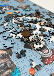 Wooden jigsaw puzzle with dog-themed pieces on a blue background