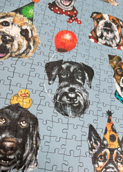 Wooden jigsaw puzzle with dog-themed pieces on a blue background