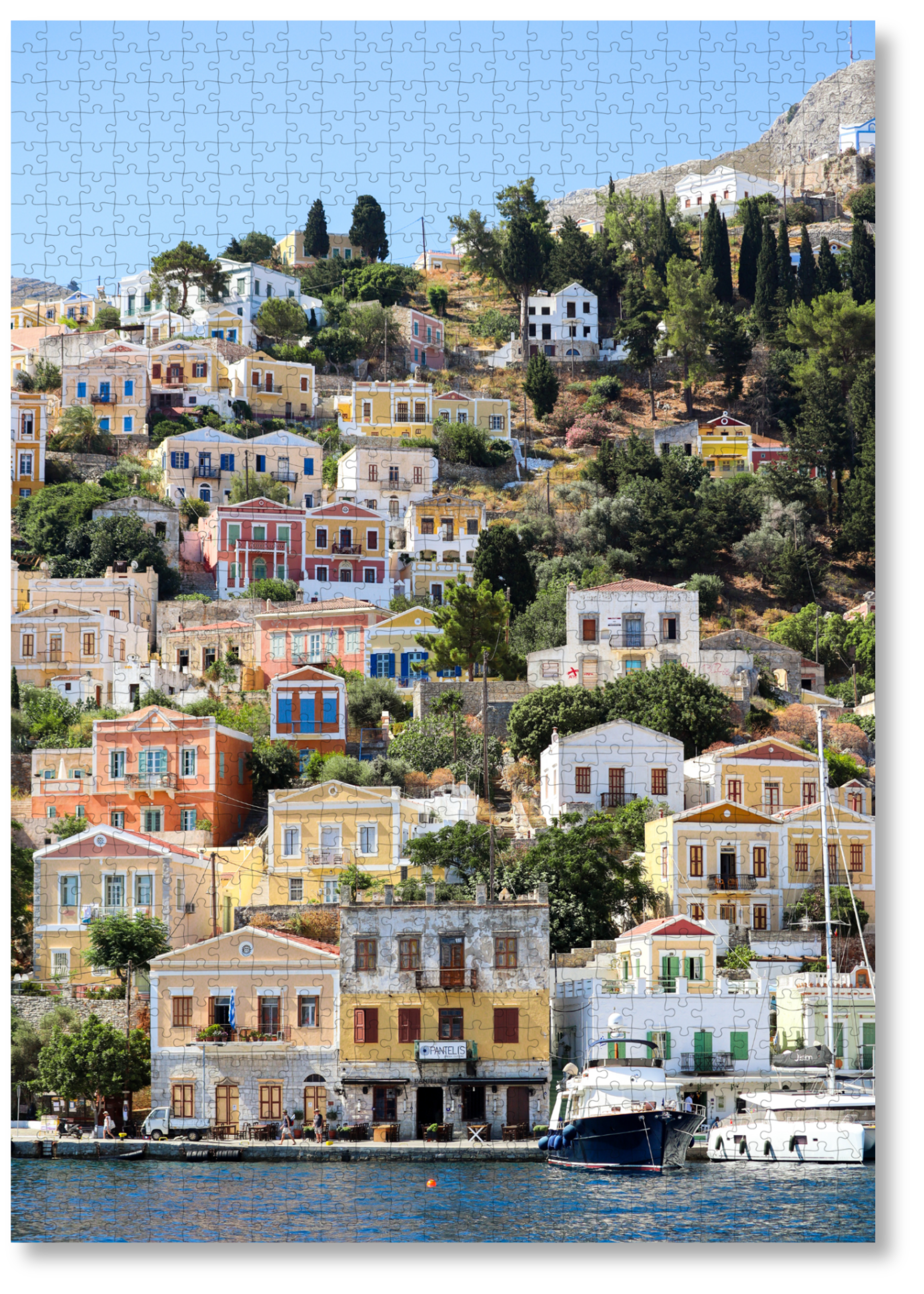Island Charm is a MasterPiece wooden jigsaw puzzle that captures the early morning view on the ferry to Symi Island in Greece, where rows of the recognisable pastel-coloured houses rise from the harbour, each one with a better view than the next. Precision-cut from 3mm thick wood and expertly printed, our MasterPiece puzzles offer a tactile and satisfying puzzling experience like no other. They are perfect for travelers, Greece lovers and anyone looking for a thoughtful gift.   