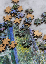 Jigsaw puzzle with completed sections and missing pieces on a marble surface.