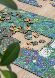 Jigsaw puzzle with a completed section  surrounded by green leaves.
