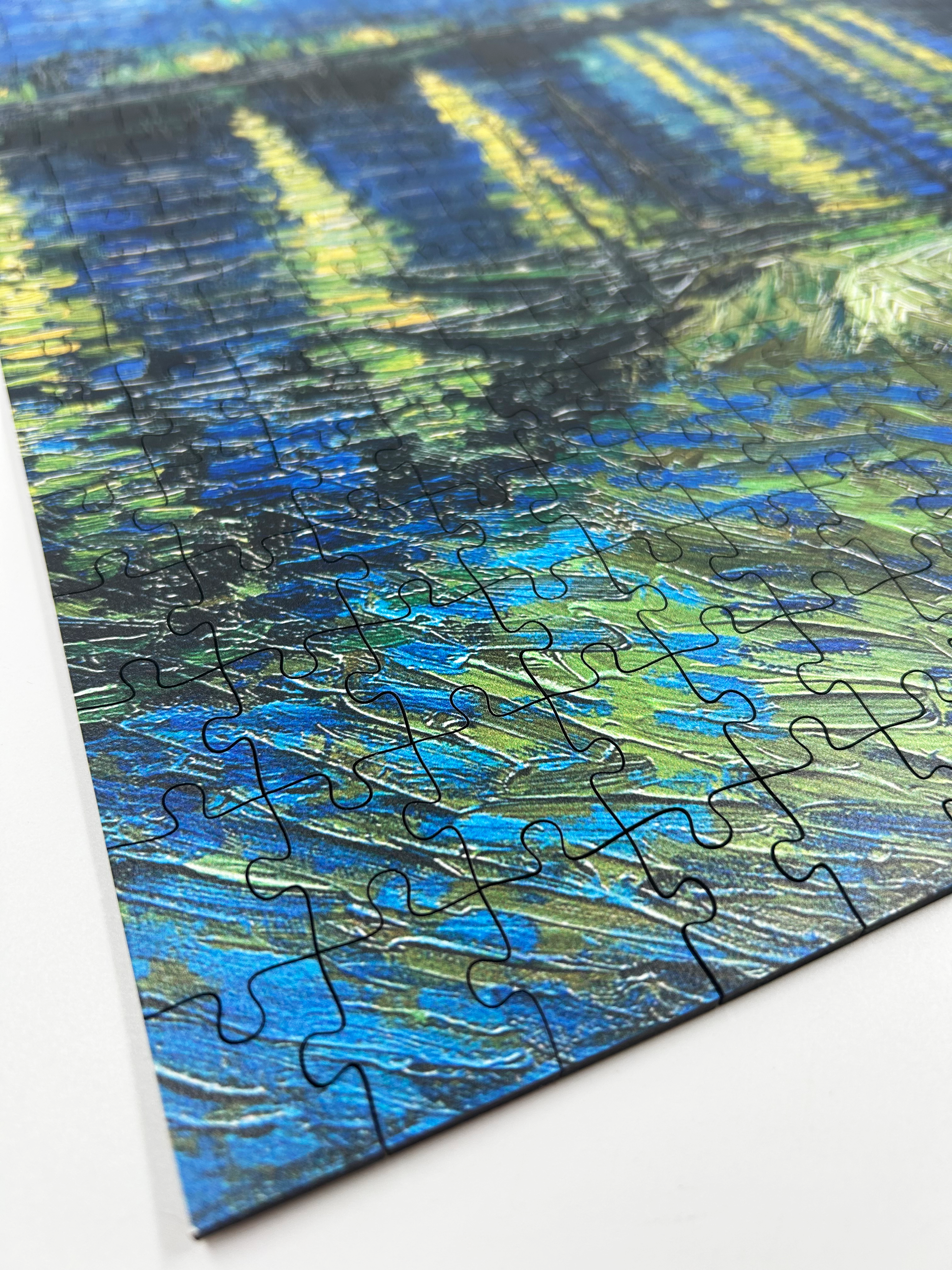 Starry Night Over the Rhône is a MasterPiece wooden jigsaw puzzle of Vincent Van Gogh's painting that depicts a serene nighttime scene of a deep blue sky filled with shimmering stars, their light reflecting off the Rhône River. Precision-cut from 3mm thick wood and expertly printed, our MasterPiece puzzles offer a tactile and satisfying puzzling experience like no other. They are perfect for classic art lovers, floral enthusiasts and anyone looking for a thoughtful gift.