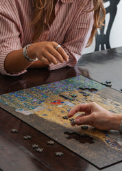 The Kiss is a MasterPiece wooden jigsaw puzzle of one of Gustav Klimt’s most celebrated paintings. This artwork of the Golden Period portrays an intimate embrace between two lovers, enveloped in a shimmering golden cloak adorned with intricate patterns. 

Precision-cut from 3mm thick wood and expertly printed, our MasterPiece puzzles offer a tactile and satisfying puzzling experience like no other. They are perfect for classic art lovers and anyone looking for a thoughtful gift.