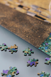 The Kiss is a MasterPiece wooden jigsaw puzzle of one of Gustav Klimt’s most celebrated paintings. This artwork of the Golden Period portrays an intimate embrace between two lovers, enveloped in a shimmering golden cloak adorned with intricate patterns. 

Precision-cut from 3mm thick wood and expertly printed, our MasterPiece puzzles offer a tactile and satisfying puzzling experience like no other. They are perfect for classic art lovers and anyone looking for a thoughtful gift.
