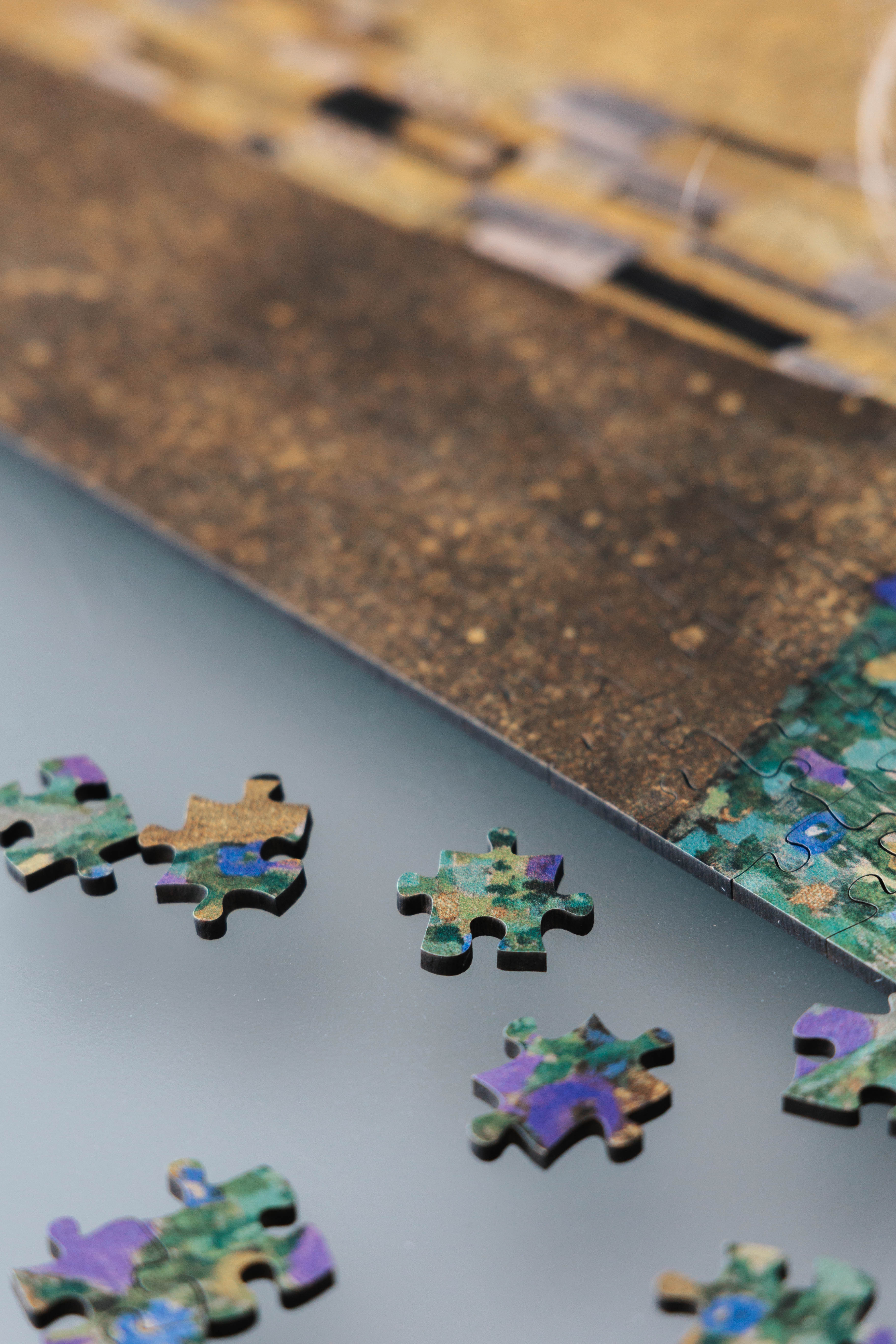 The Kiss is a MasterPiece wooden jigsaw puzzle of one of Gustav Klimt’s most celebrated paintings. This artwork of the Golden Period portrays an intimate embrace between two lovers, enveloped in a shimmering golden cloak adorned with intricate patterns. 

Precision-cut from 3mm thick wood and expertly printed, our MasterPiece puzzles offer a tactile and satisfying puzzling experience like no other. They are perfect for classic art lovers and anyone looking for a thoughtful gift.