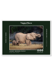 Trunks in Tandem is a MasterPiece wooden jigsaw puzzle that features a beautiful photograph of an elephant and elephant calf both drinking water with their trunks in their mouths.

Precision-cut from 3mm wood and expertly printed, our MasterPiece puzzles offer a tactile and satisfying puzzling experience like no other. They are perfect for wildlife lovers, nature enthusiasts and anyone looking for a thoughtful gift.