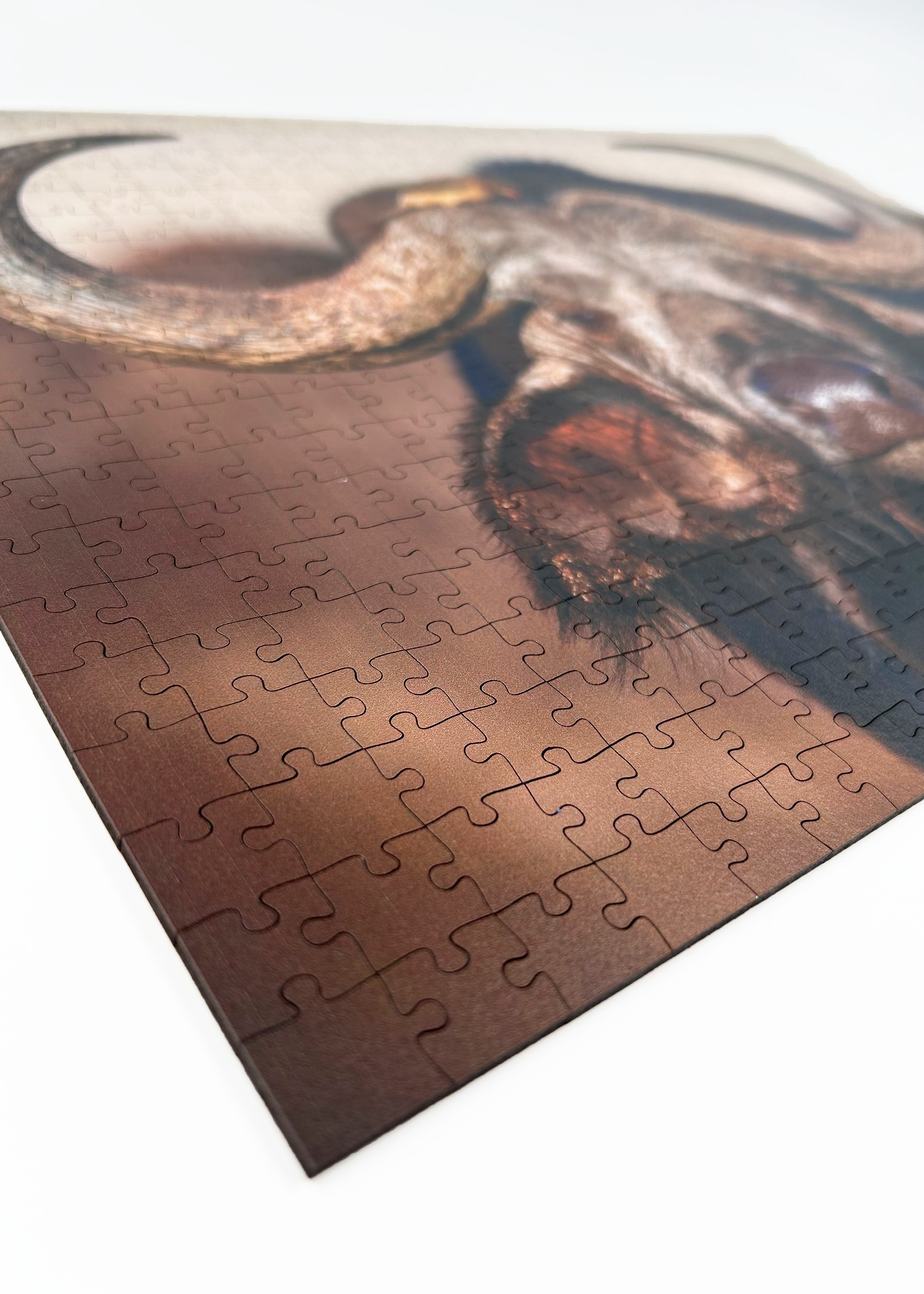 MasterPiece luxury wooden puzzle of a South African wildlife photograph of a buffalo and ox-pecker taken by Isak Pretorius. A way to disconnect, relieve stress and a great gift idea.