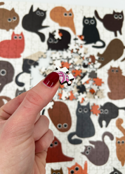 Curious Cats is a MasterPiece wooden jigsaw puzzle featuring a delightful collection of curious cats in various poses and playful scenes. This charming puzzle is a must-have for cat lovers! Precision-cut from 3mm thick wood and expertly printed, our MasterPiece puzzles offer a tactile and satisfying puzzling experience like no other. like no other. This puzzle is perfect for 'crazy cat ladies', art lovers and anyone looking for a thoughtful gift.