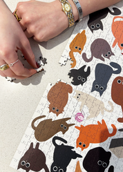 Curious Cats is a MasterPiece wooden jigsaw puzzle featuring a delightful collection of curious cats in various poses and playful scenes. This charming puzzle is a must-have for cat lovers! Precision-cut from 3mm thick wood and expertly printed, our MasterPiece puzzles offer a tactile and satisfying puzzling experience like no other. like no other. This puzzle is perfect for 'crazy cat ladies', art lovers and anyone looking for a thoughtful gift.