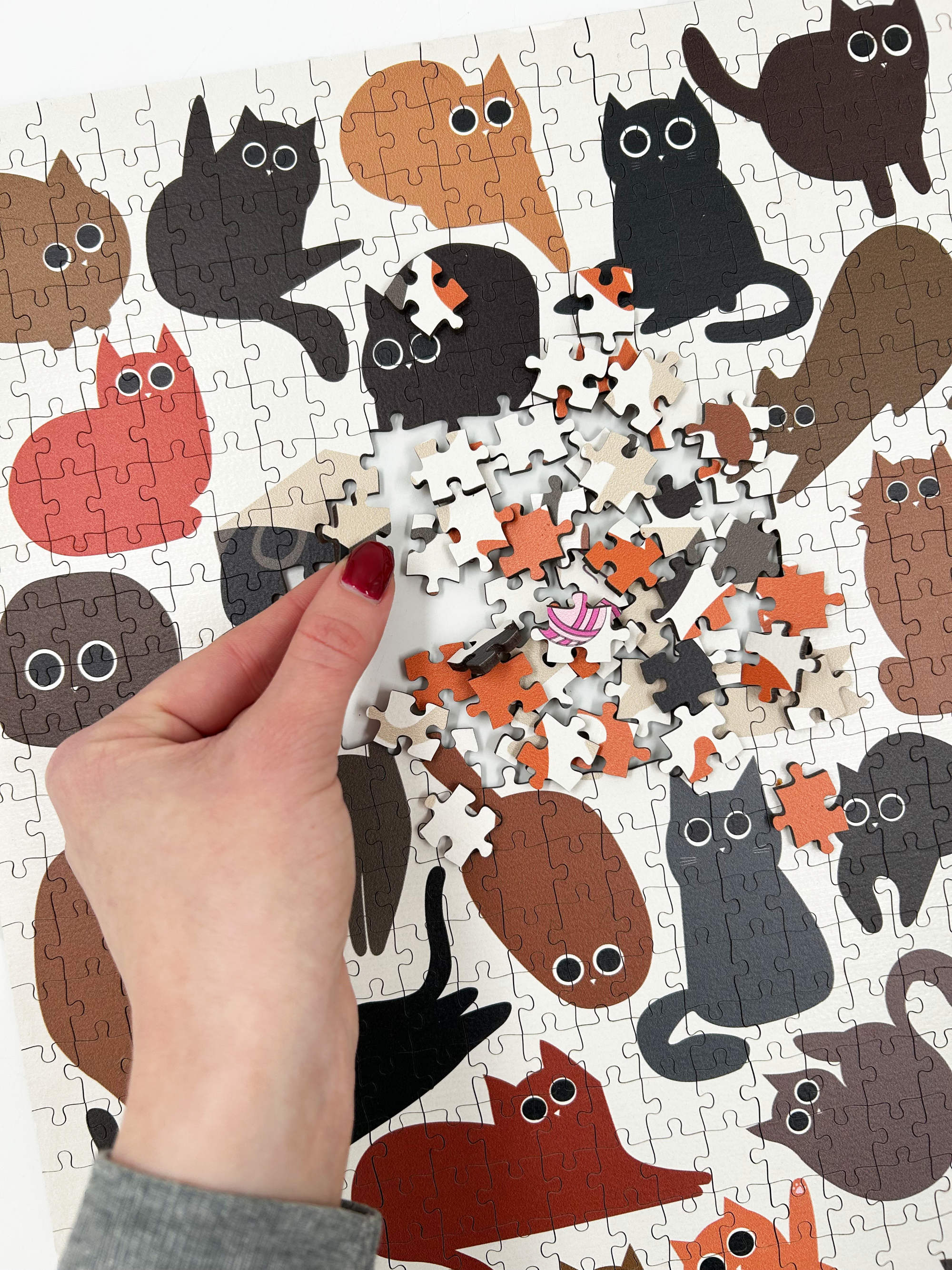 Jigsaw puzzle with cat illustrations. A great gift idea for cat lovers and puzzlers. Also can be framed as artwork for wall decor once complete.