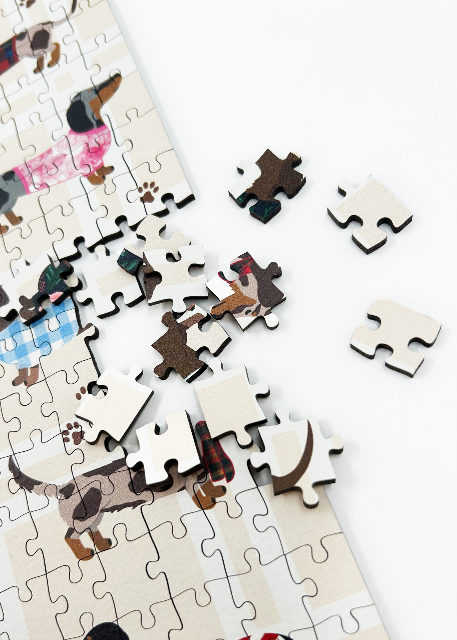 Stylish Sausages is a MasterPiece wooden jigsaw puzzle featuring an adorable line-up of sausage dogs strutting their stuff in various colourful jerseys and scarves, a must-have for dachshund lovers!

Precision-cut from 3mm thick wood and expertly printed, our MasterPiece puzzles offer a tactile and satisfying puzzling experience like no other. This puzzle is perfect for dachshund lovers and anyone looking for a thoughtful gift. 