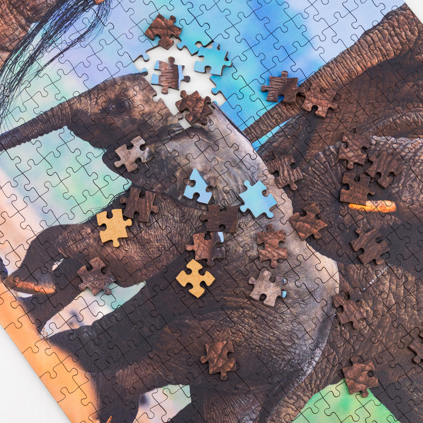 MasterPiece luxury wooden puzzle of a South African wildlife photograph of an elephant calf with other elephants taken by Hendri Venter. A way to disconnect, relieve stress and a great gift idea.