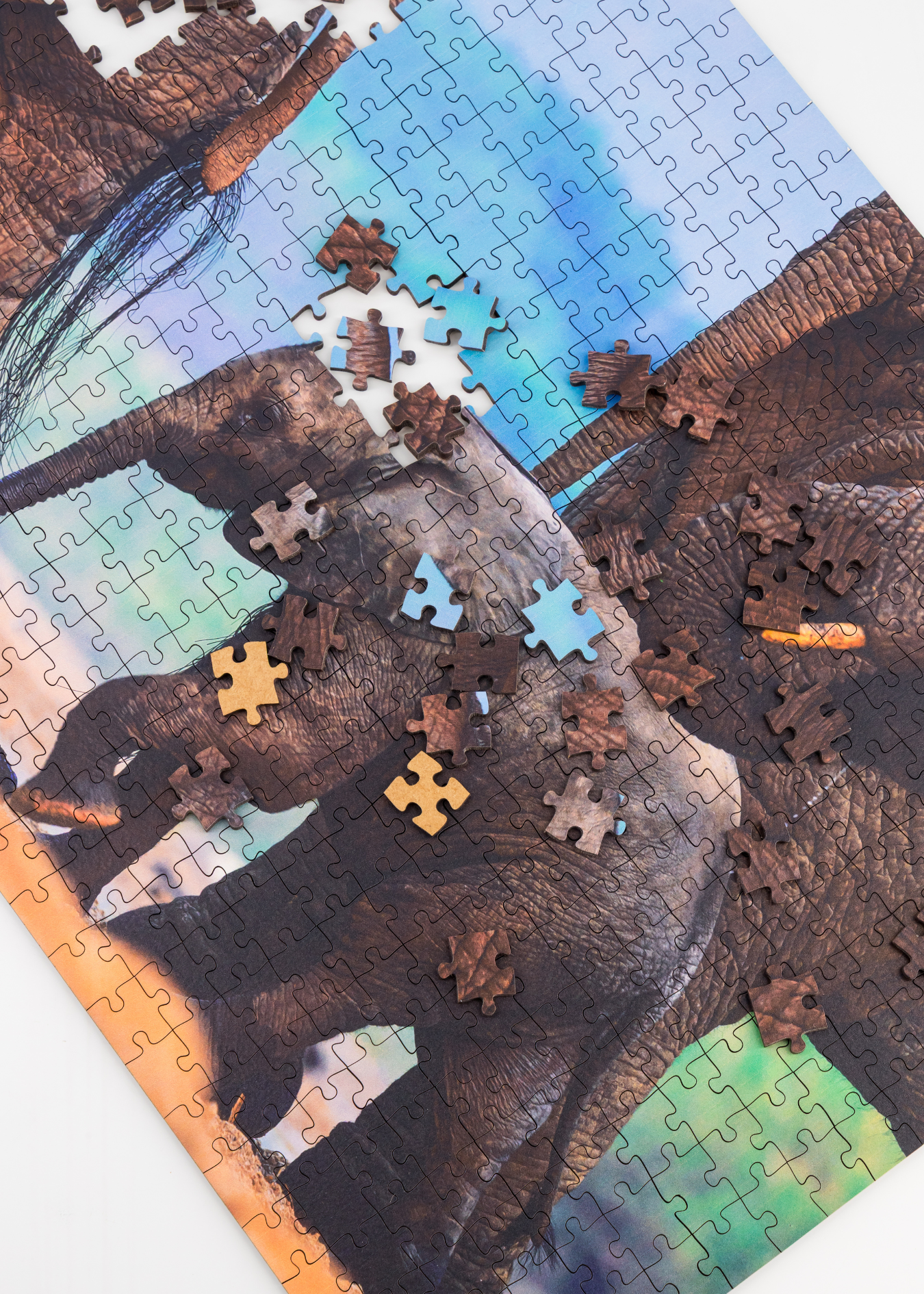 MasterPiece luxury wooden puzzle of a South African wildlife photograph of an elephant calf with other elephants taken by Hendri Venter. A way to disconnect, relieve stress and a great gift idea.