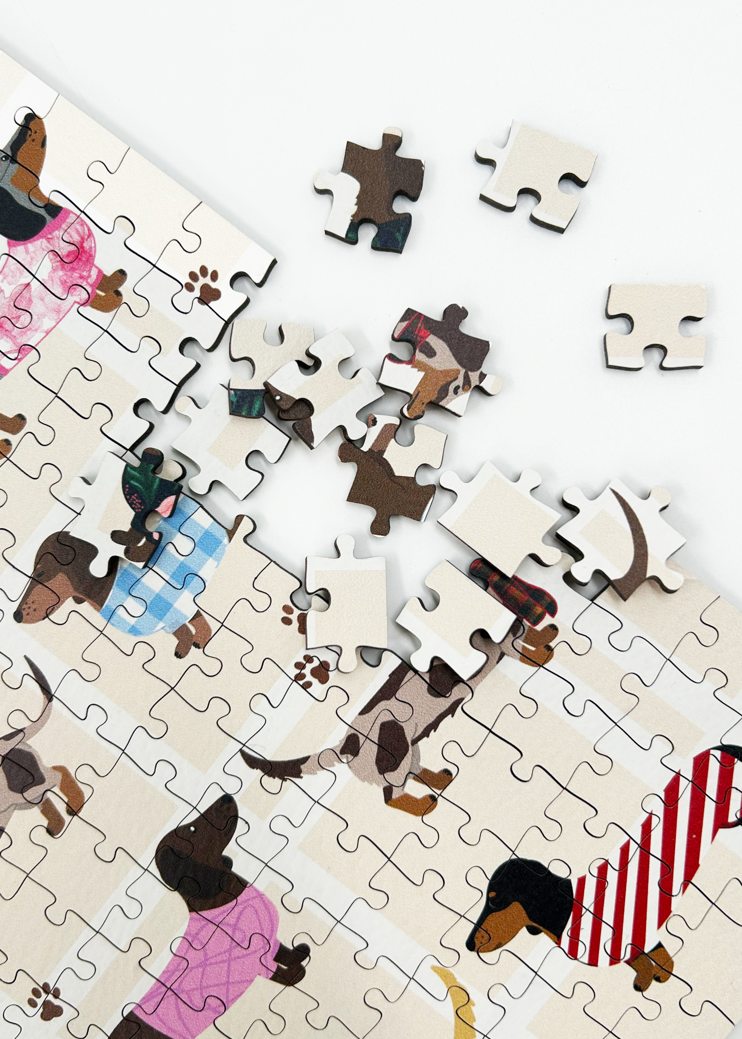 Stylish Sausages is a MasterPiece wooden jigsaw puzzle featuring an adorable line-up of sausage dogs strutting their stuff in various colourful jerseys and scarves, a must-have for dachshund lovers!

Precision-cut from 3mm thick wood and expertly printed, our MasterPiece puzzles offer a tactile and satisfying puzzling experience like no other. This puzzle is perfect for dachshund lovers and anyone looking for a thoughtful gift. 