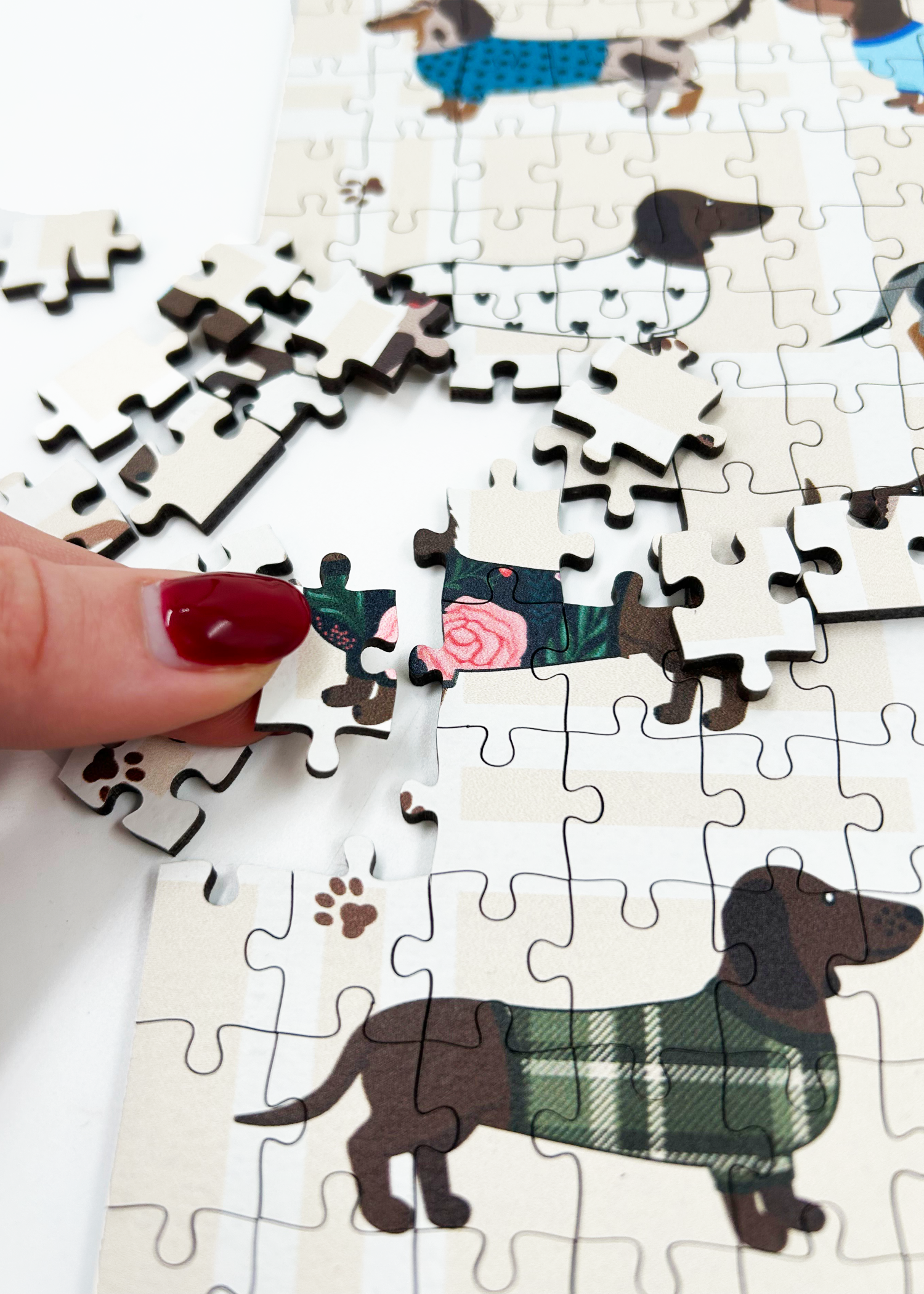 Stylish Sausages is a MasterPiece wooden jigsaw puzzle featuring an adorable line-up of sausage dogs strutting their stuff in various colourful jerseys and scarves, a must-have for dachshund lovers!

Precision-cut from 3mm thick wood and expertly printed, our MasterPiece puzzles offer a tactile and satisfying puzzling experience like no other. This puzzle is perfect for dachshund lovers and anyone looking for a thoughtful gift. 