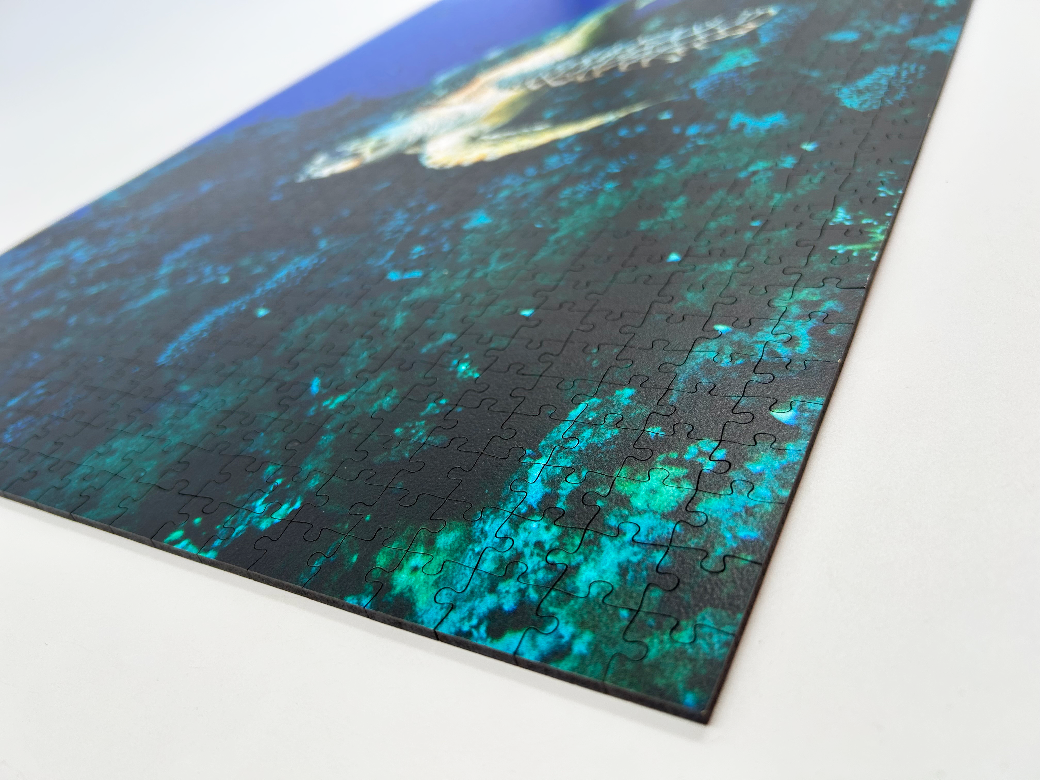 Turtle is a MasterPiece wooden jigsaw puzzle that features a beautiful underwater photograph of a turtle swimming in front of a coral reef.

Precision-cut from 3mm wood and expertly printed, our MasterPiece puzzles offer a tactile and satisfying puzzling experience like no other. They are perfect for ocean lovers, nature enthusiasts and anyone looking for a thoughtful gift.