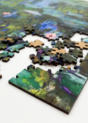 Water Lilies is a MasterPiece wooden jigsaw puzzle of one of Claude Monet’s iconic paintings. This Impressionist piece captures the tranquil beauty of his garden in Giverny. The artwork showcases a  pond filled with water lilies in soft, blended hues of blue, green and pink. 

Precision-cut from 3mm wood and expertly printed, our MasterPiece puzzles offer a tactile and satisfying puzzling experience like no other. They are perfect for classic art lovers and anyone looking for a thoughtful gift.