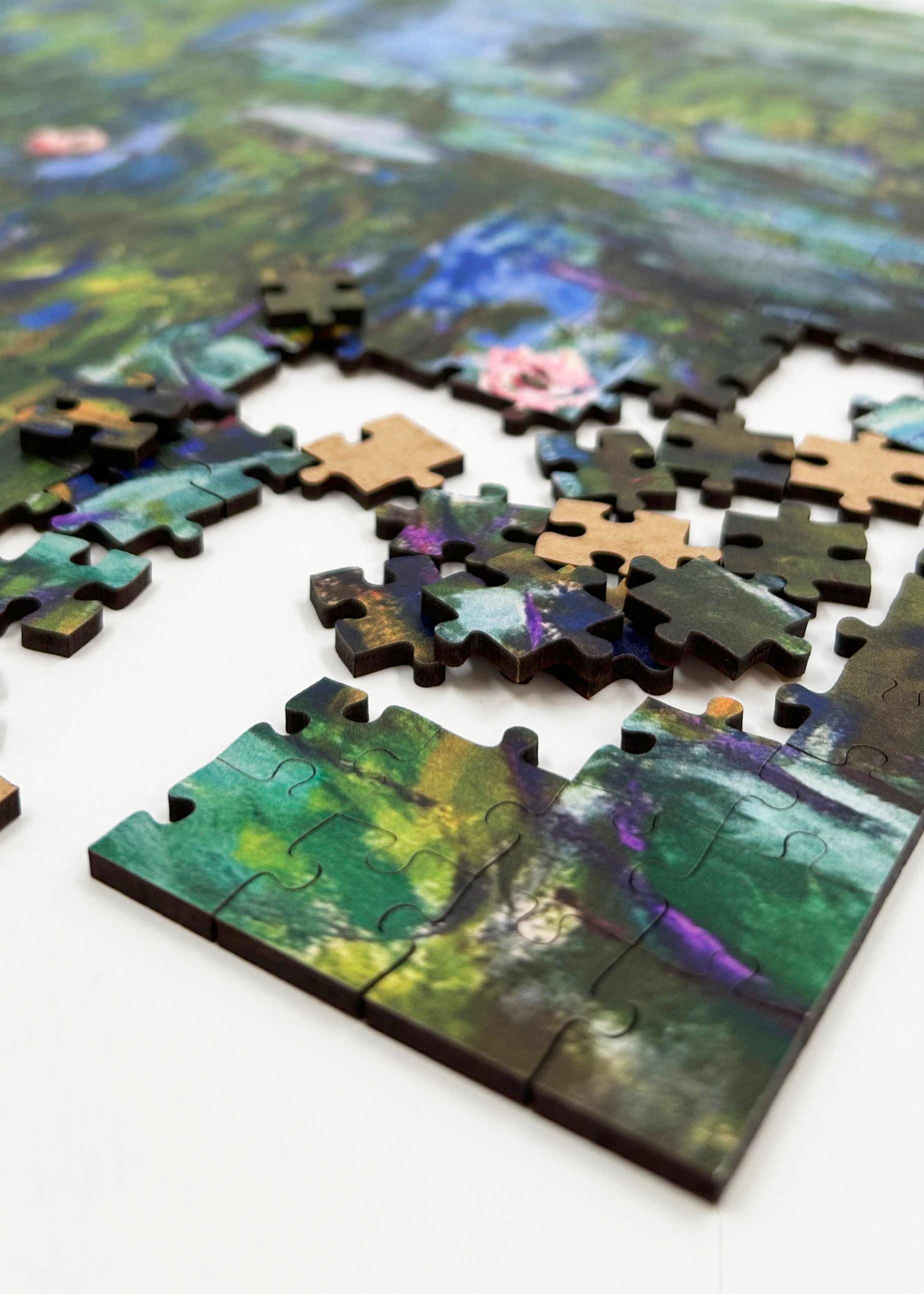 Water Lilies is a MasterPiece wooden jigsaw puzzle of one of Claude Monet’s iconic paintings. This Impressionist piece captures the tranquil beauty of his garden in Giverny. The artwork showcases a  pond filled with water lilies in soft, blended hues of blue, green and pink. 

Precision-cut from 3mm wood and expertly printed, our MasterPiece puzzles offer a tactile and satisfying puzzling experience like no other. They are perfect for classic art lovers and anyone looking for a thoughtful gift.