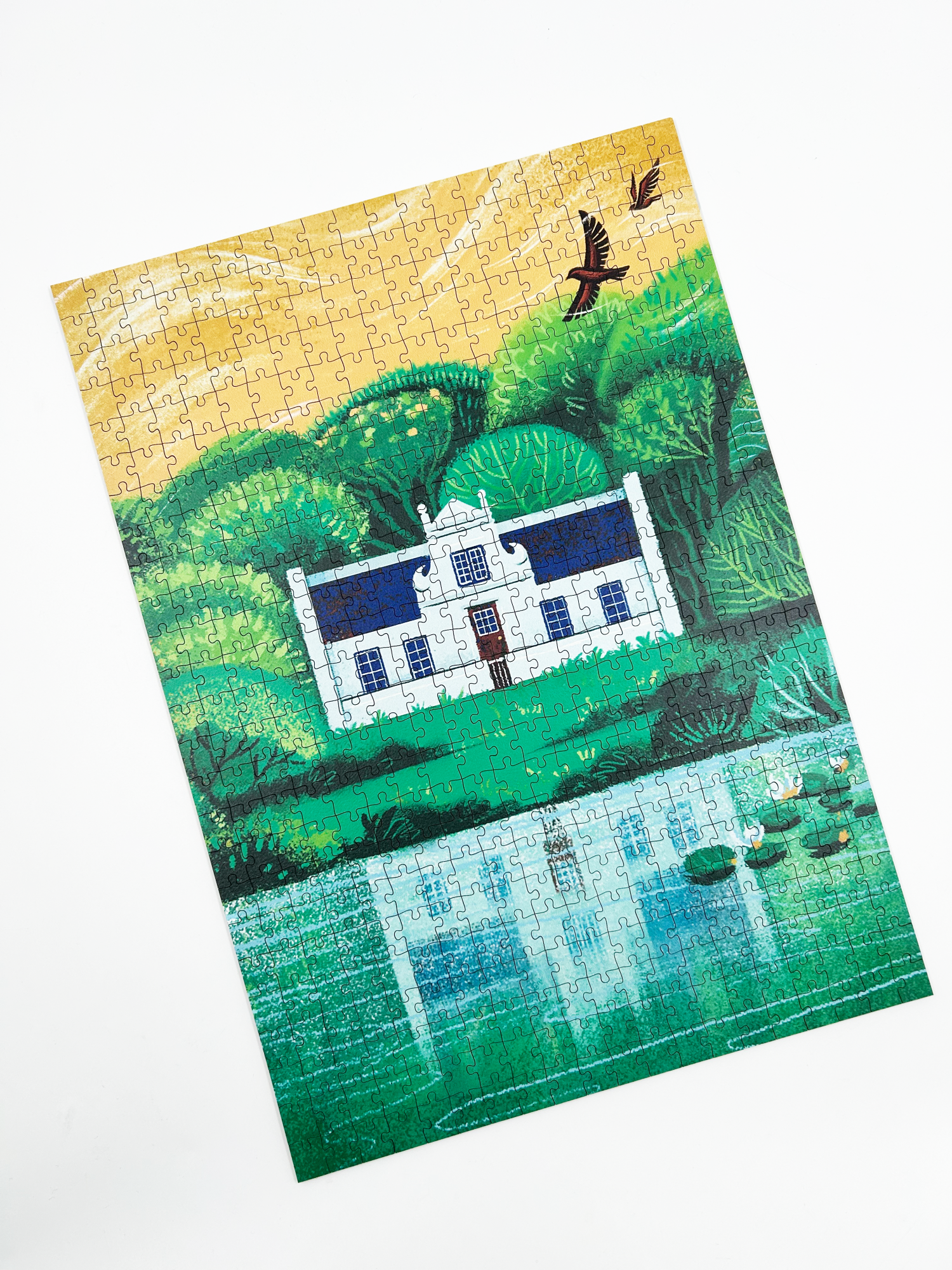 A wooden jigsaw puzzle featuring an illustration of the Zevenwacht Wine Estate manor house. Perfect for art lovers and anyone looking for a thoughtful gift. 