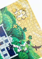 A wooden jigsaw puzzle featuring an illustration of the Zevenwacht Wine Estate manor house. Perfect for art lovers and anyone looking for a thoughtful gift. 