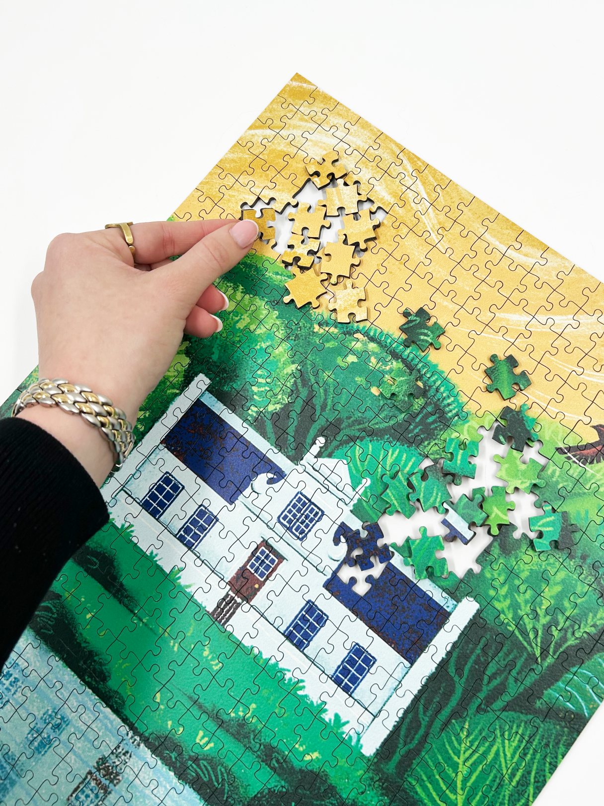 A wooden jigsaw puzzle featuring an illustration of the Zevenwacht Wine Estate manor house. Perfect for art lovers and anyone looking for a thoughtful gift. 